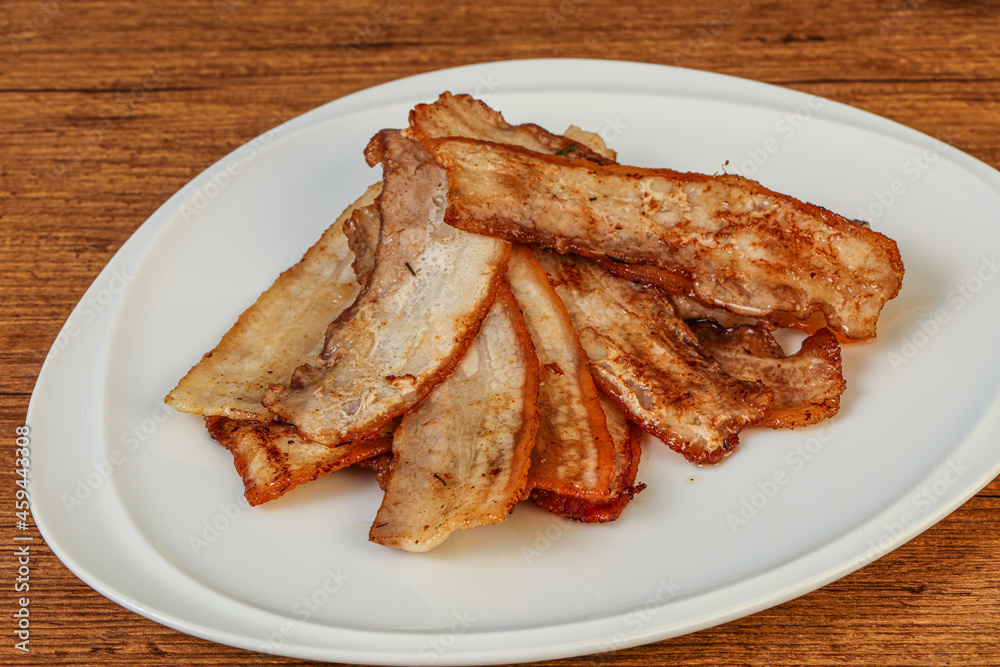 Roasted juicy bacon in the plate Roasted juicy bacon in the plate