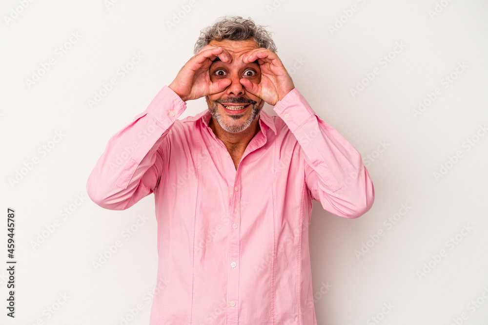 Middle age caucasian man isolated on white background showing okay sign over eyes Middle age caucasian man isolated on white background showing okay sign over eyes