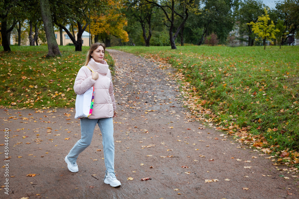 eco girl walking in park with coffee cup ang bag eco girl walking in park with coffee cup ang bag