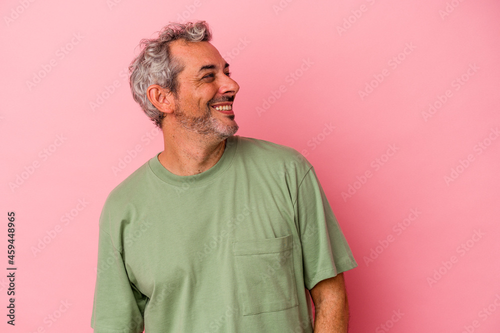 Middle age caucasian man isolated on pink background relaxed and happy laughing, neck stretched showing teeth. Middle age caucasian man isolated on pink background relaxed and happy laughing, neck stretched showing teeth.