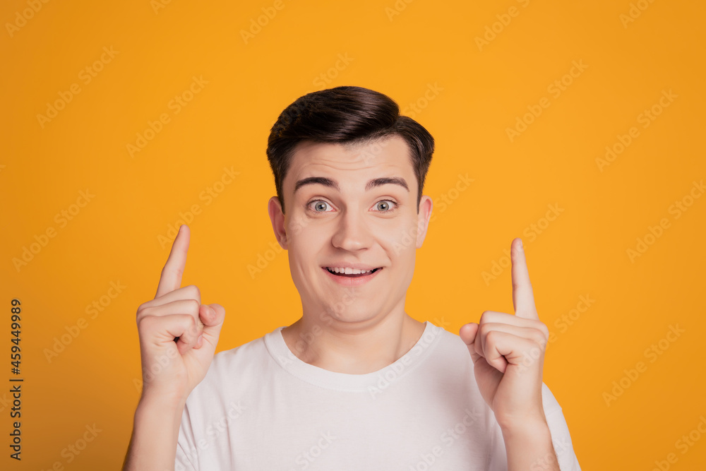Portrait of adviser guy amazed reaction promoting sale direct fingers blank space on yellow background Portrait of adviser guy amazed reaction promoting sale direct fingers blank space on yellow background