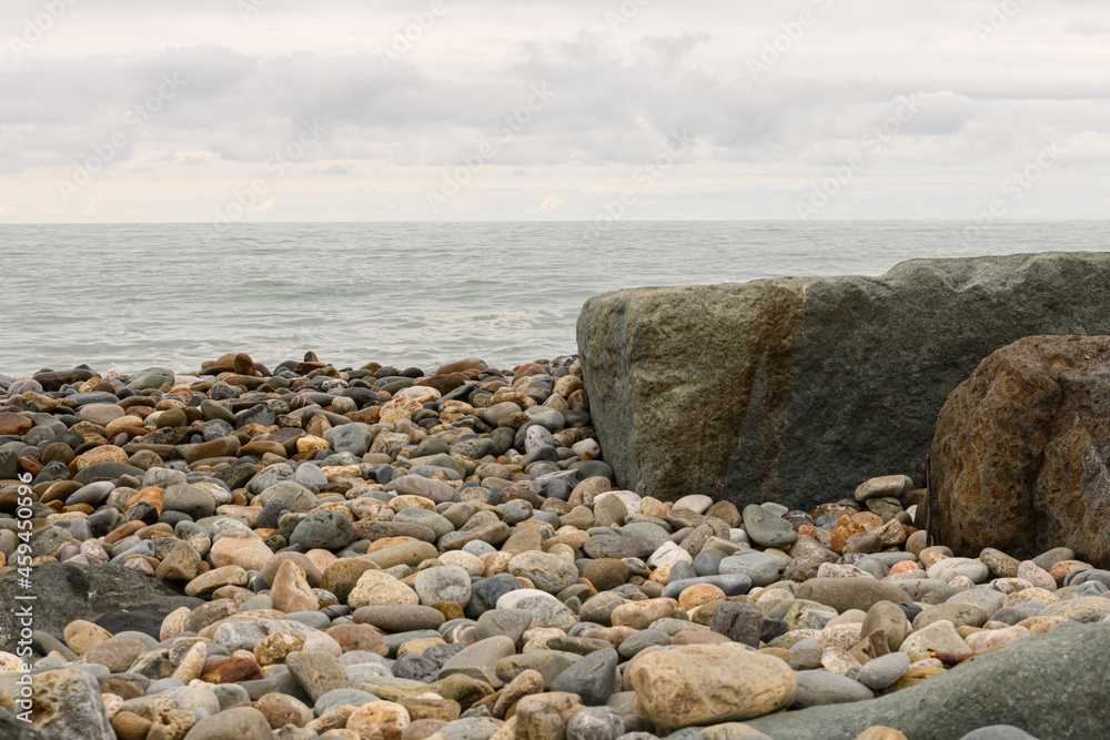View of large stones in the sea and on the beach. . High quality photo