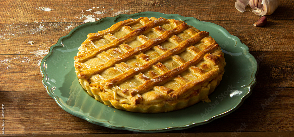Brazilian Chicken Pie - Homemade Chicken Pie on Spatula on a Wooden Table Rustic Appeal Brazilian Chicken Pie - Homemade Chicken Pie on Spatula on a Wooden Table Rustic Appeal