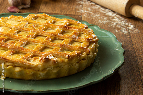 Brazilian Chicken Pie -  Homemade Chicken Pie on Spatula on a Wooden Table Rustic Appeal