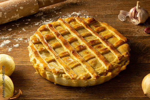 Brazilian Chicken Pie -  Homemade Chicken Pie on Spatula on a Wooden Table Rustic Appeal photo