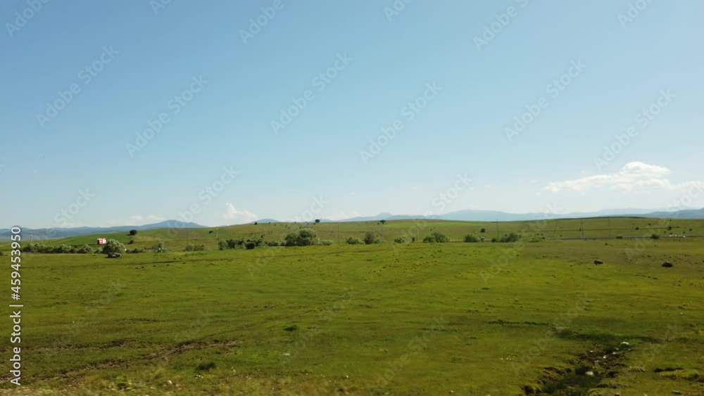 aerial view of a green field and highland aerial view of a green field and highland