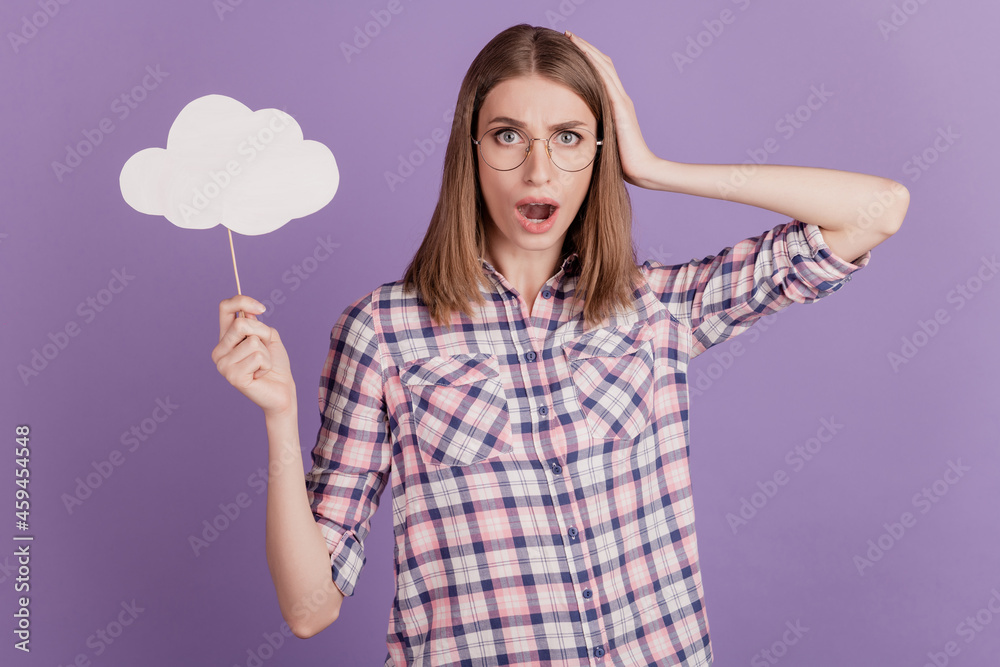 Portrait of attractive lovely lady amazed shocked fake news hold clouds bubble isolated on violet color background