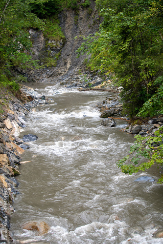 Vertical shot of a river in Liechtensteinklamm gorge in Pongau, Austria photo