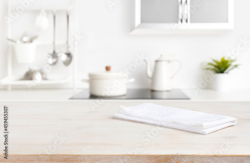 White napkin on table with blurred kitchen cooking zone background © didecs