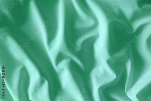 Crumpled mint-coloured fabric background
