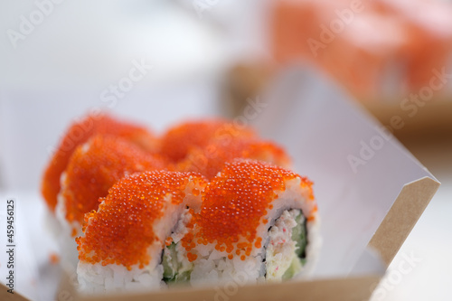 Sushi with flying fish roe lying on table closeup