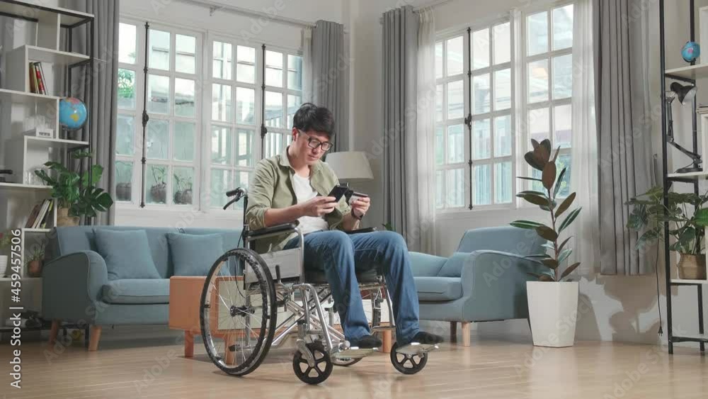 Asian Man Sitting In A Wheelchair While Use Mobile Phone And Credit Card Shopping Online At Home
Asian Man Sitting In A Wheelchair While Use Mobile Phone And Credit Card Shopping Online At Home