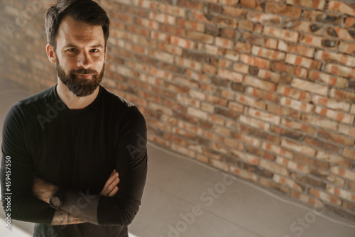 Mid aged bearded sportsman wearing smartwatch