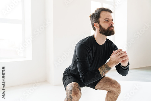 Confident mid aged white sportsman exercising