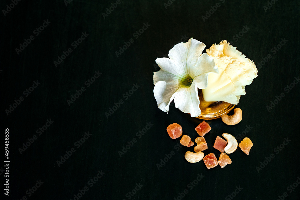 Fototapeta premium Savory pieces of cheese served with nuts, fruit and honey. Cheese of different varieties on a wooden plate. Dark background.