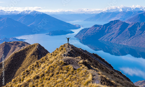 Asian traveler celebrating success at Roy's Peak Lake Wanaka New Zealand photo