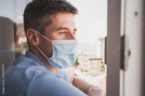A man in isolation with a cold. A man with a medical mask. Close-up of the face of a masked man.
