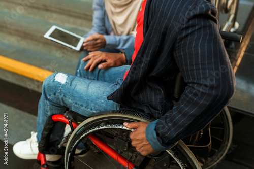 Woman and disabled man using tablet computer together