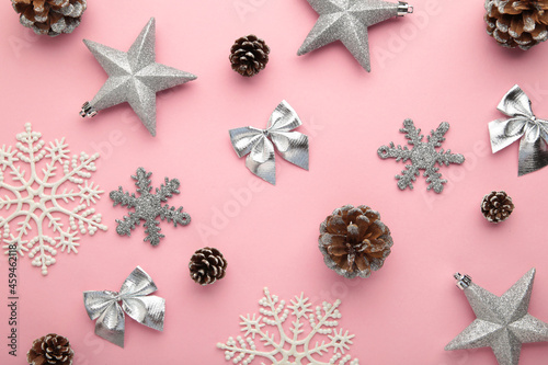 Christmas silver baubles on pink background. New Year composition