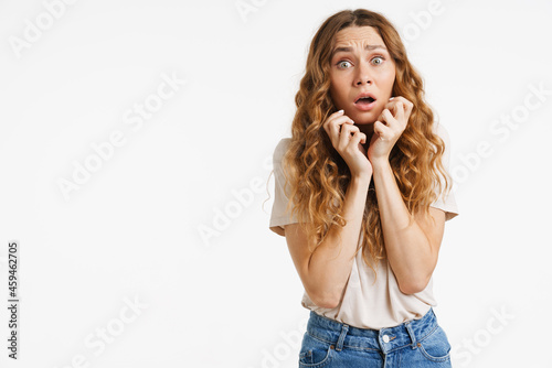Young ginger woman gesturing while expressing surprise at camera