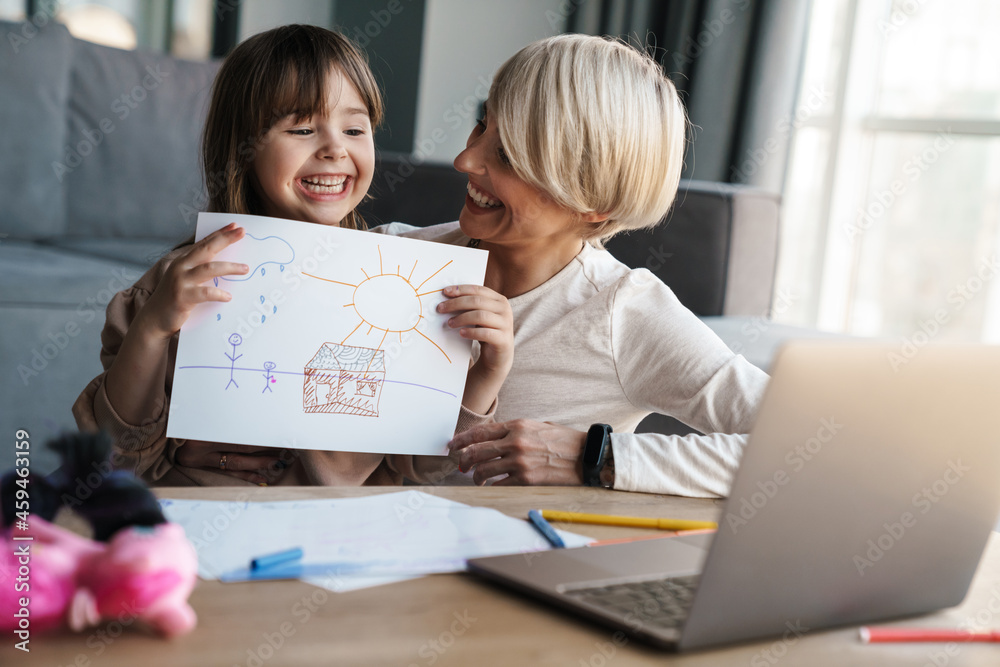 Mother helping her daughter with her homework Mother helping her daughter with her homework