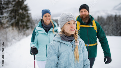 Happy family with small daughter walking outdoors in winter nature, Tatra mountains Slovakia.