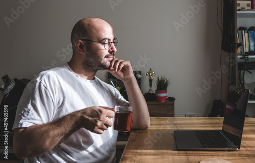 Young man taking a tea break while working at home. young man working from his home.