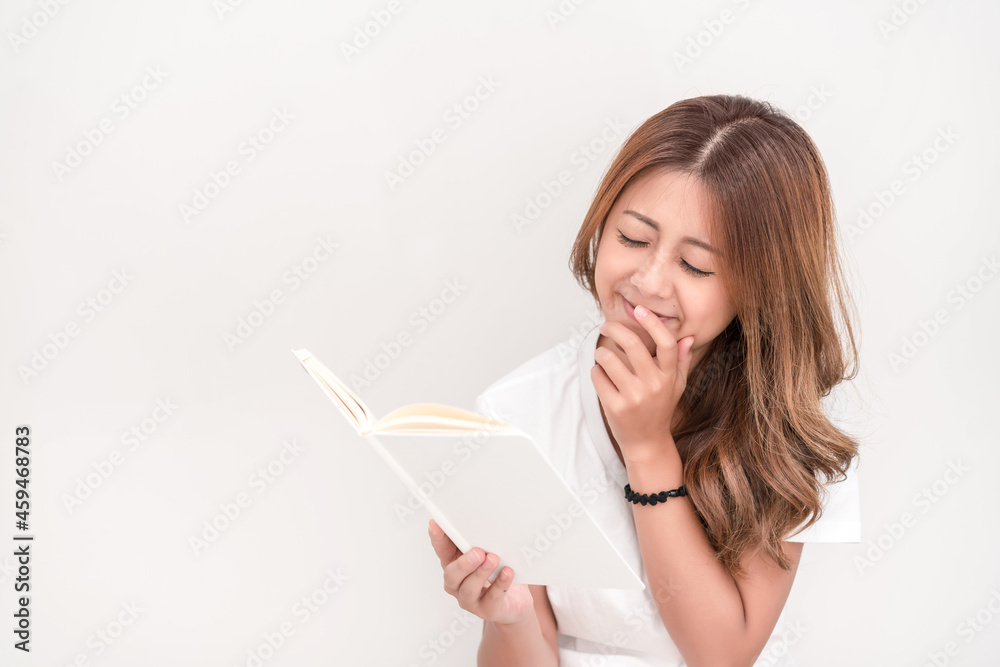 Young attractive asian student holding books in her arm on white background. School girl with a books to read for homework. Young attractive asian student holding books in her arm on white background. School girl with a books to read for homework.