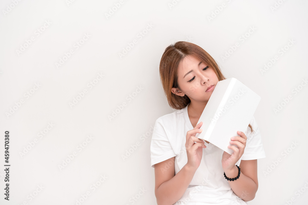 Young attractive asian student holding books in her arm on white background. School girl with a books to read for homework. Young attractive asian student holding books in her arm on white background. School girl with a books to read for homework.