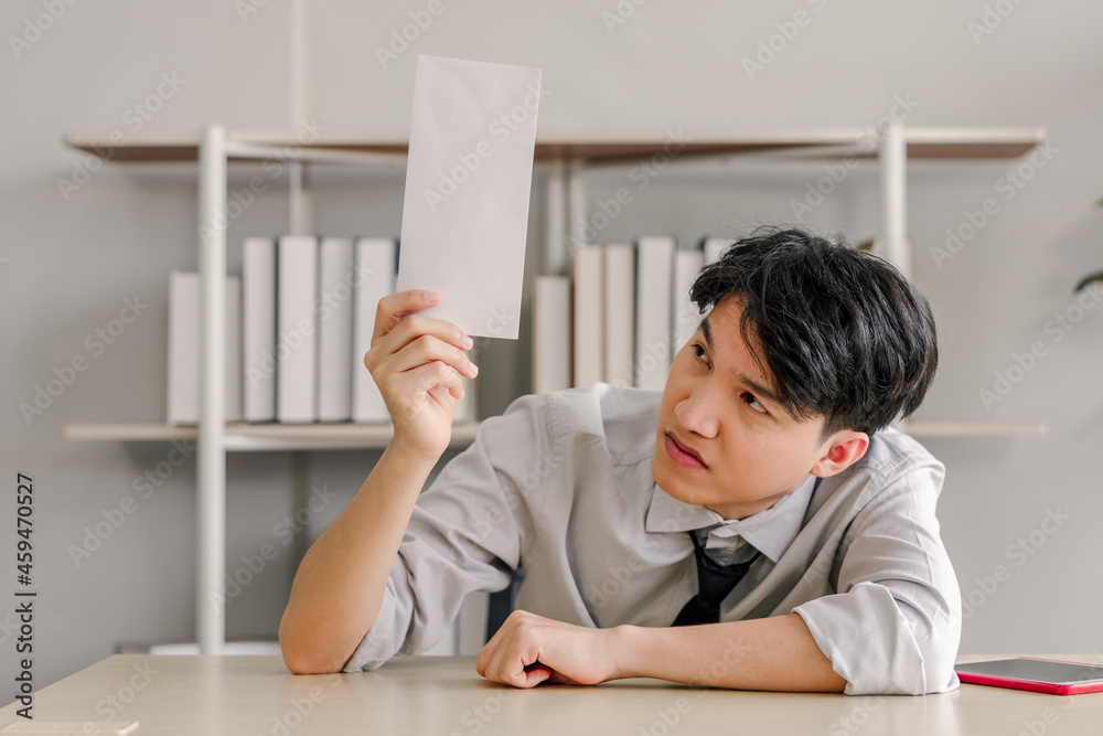 young asian businessman was stressed when he received termination documents deadline young asian businessman was stressed when he received termination documents deadline
