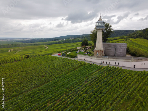 View on lighthouse and green pinot noir grand cru vineyards of famous champagne houses in Montagne de Reims near Verzenay, Champagne, France © barmalini