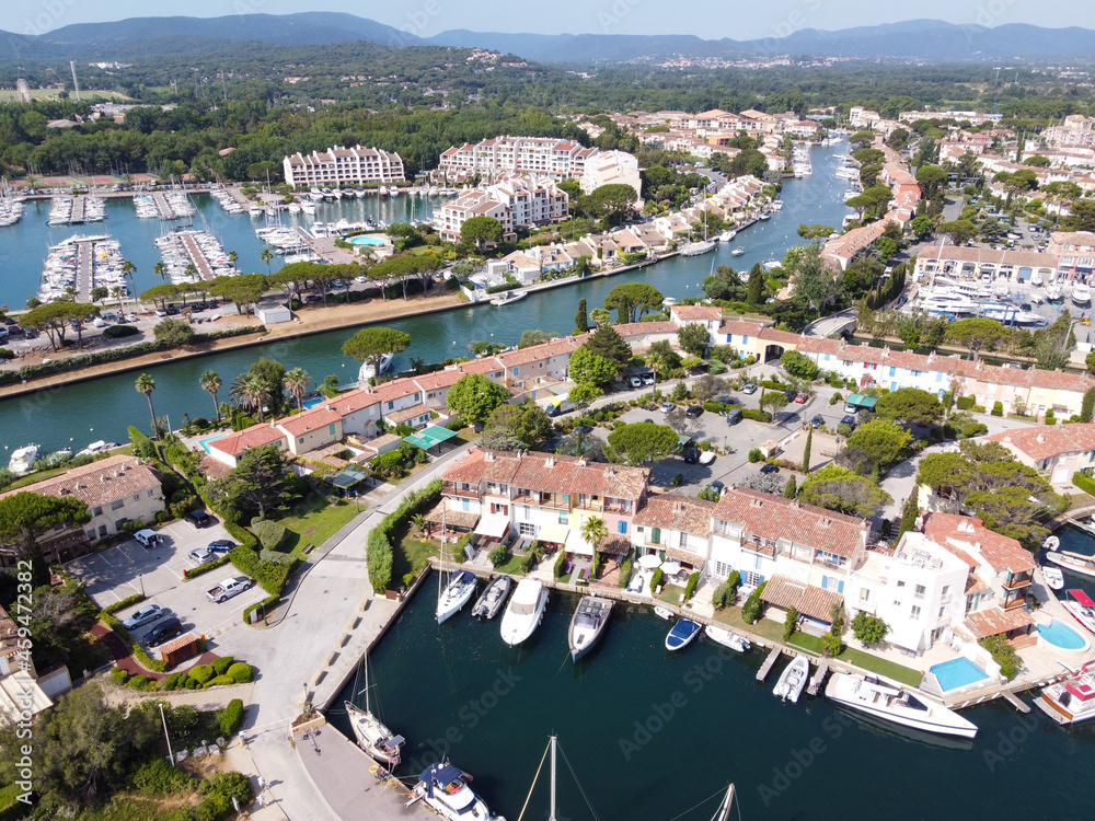 Aerial view on small houses and sailboats of Port Grimaud and port Cogolin, French Riviera, Provence, France