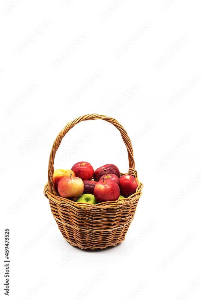 Basket of fresh, ripe apples on white. Various red and green apple fruits in wicker basket. Basket of fresh, ripe apples on white. Various red and green apple fruits in wicker basket.