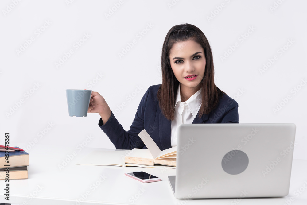 Beautiful office woman sit at table in office ,she work with laptop and use pen write report on notebook. Beautiful office woman sit at table in office ,she work with laptop and use pen write report on notebook.