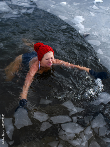 High-angle view of active senior woman in swimsuit outdoors in winter, cold therapy concept.