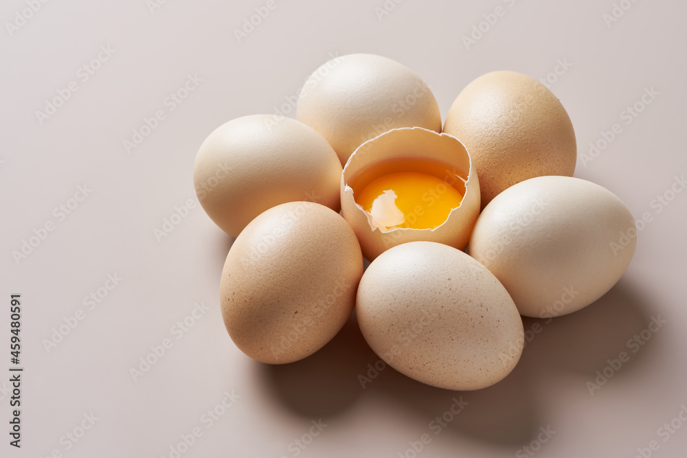 Eggs and egg yolk on the cream background