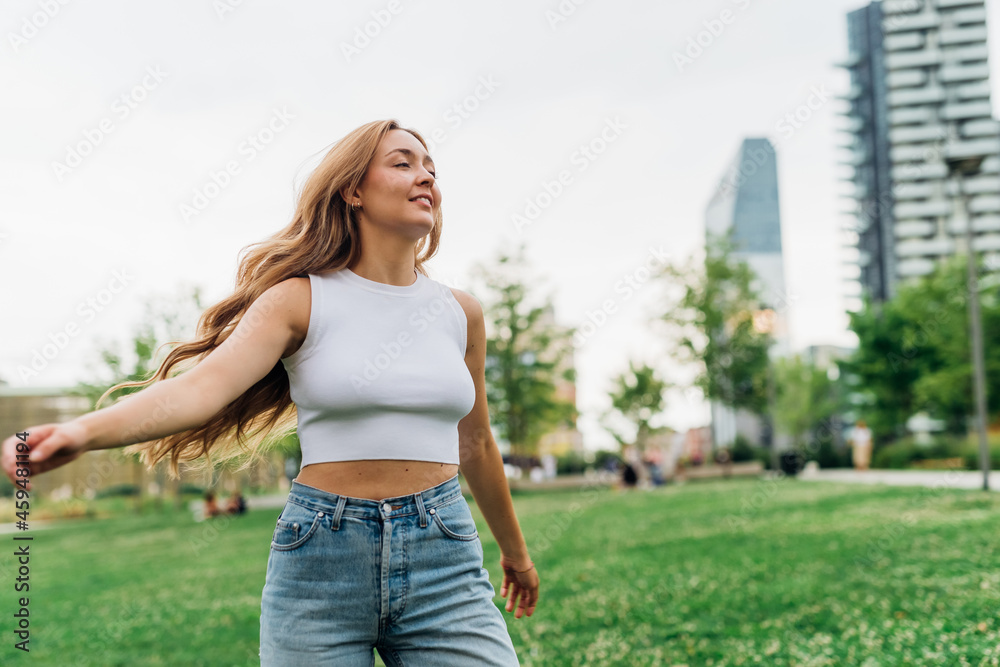 Young caucasian healthy woman outdoor dancing and feeling free ehaving fun enjoying fresh hair Young caucasian healthy woman outdoor dancing and feeling free ehaving fun enjoying fresh hair