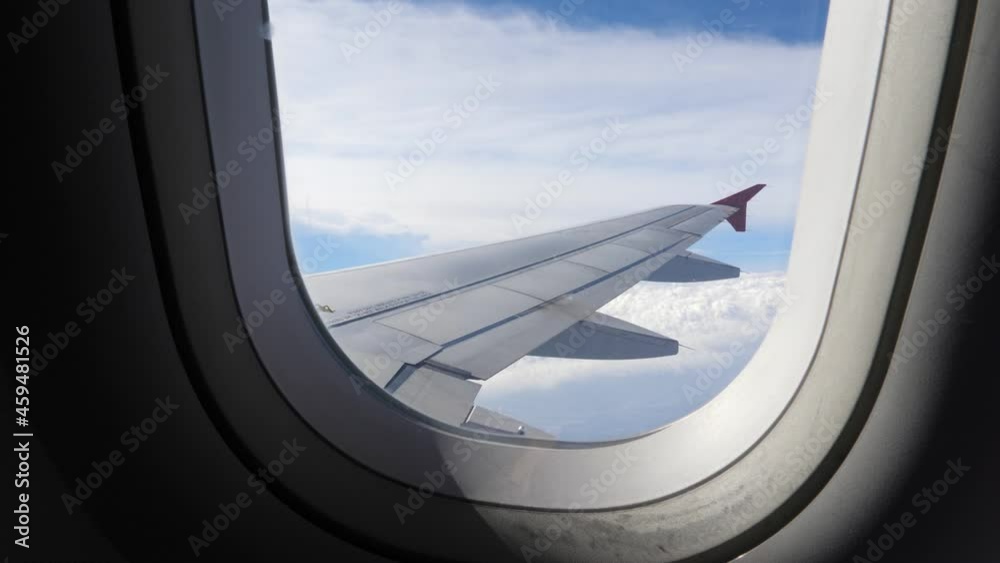 Airplane wing. Looking through plane window. Travel concept Airplane wing. Looking through plane window. Travel concept