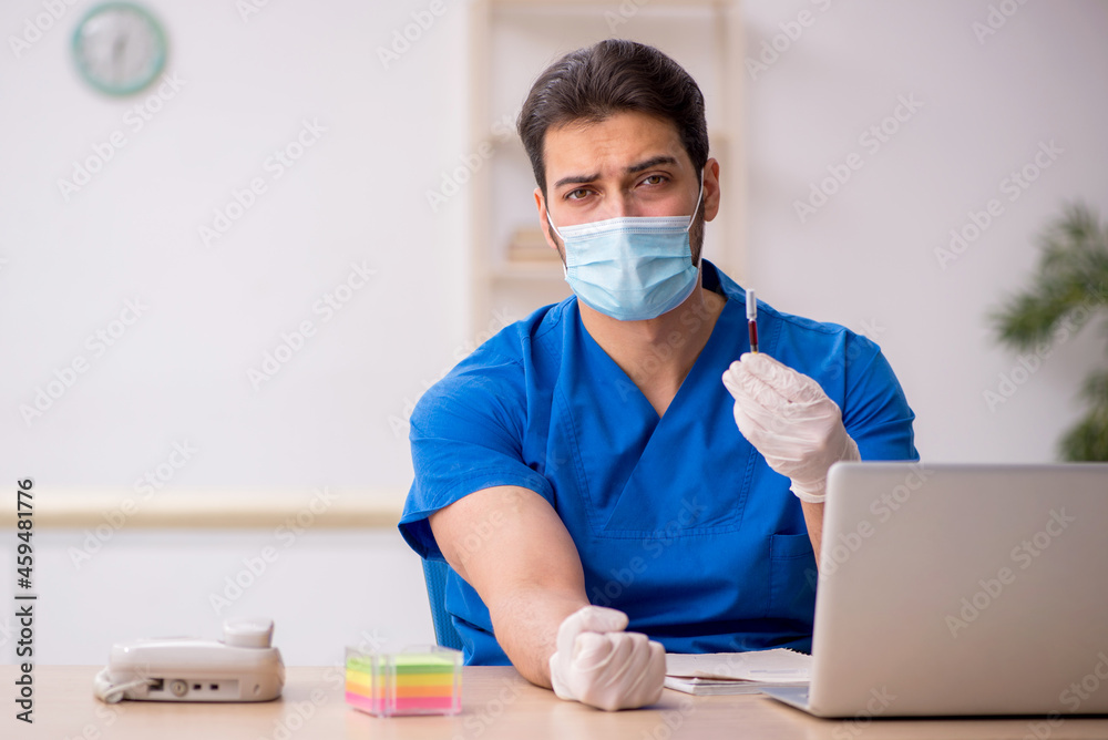Young male doctor in vaccination concept Young male doctor in vaccination concept