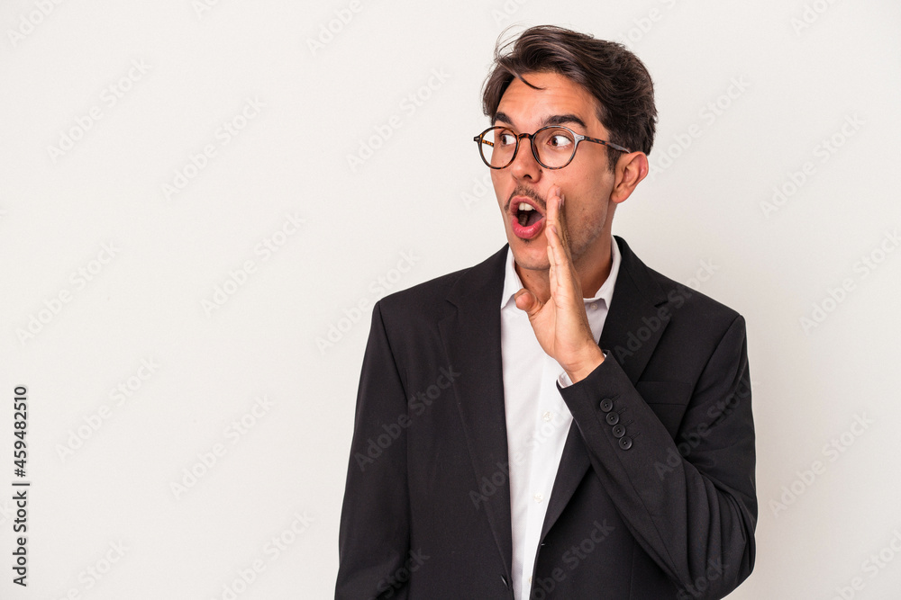 Young mixed race business man isolated on white background is saying a secret hot braking news and looking aside Young mixed race business man isolated on white background is saying a secret hot braking news and looking aside