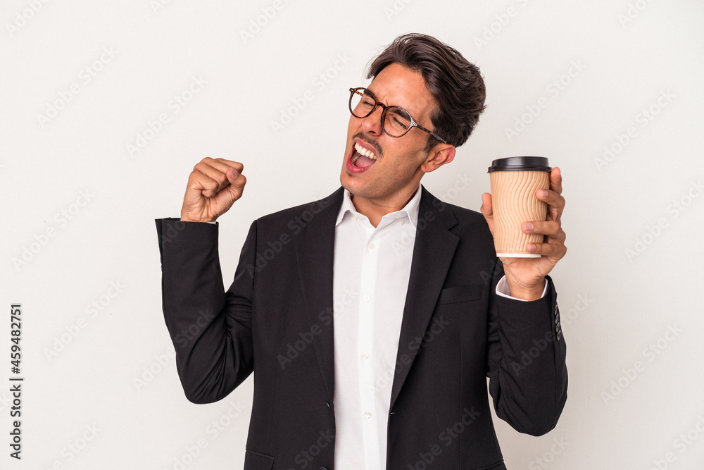 Young mixed race business man holding take away coffee isolated on white background raising fist after a victory, winner concept. Young mixed race business man holding take away coffee isolated on white background raising fist after a victory, winner concept.