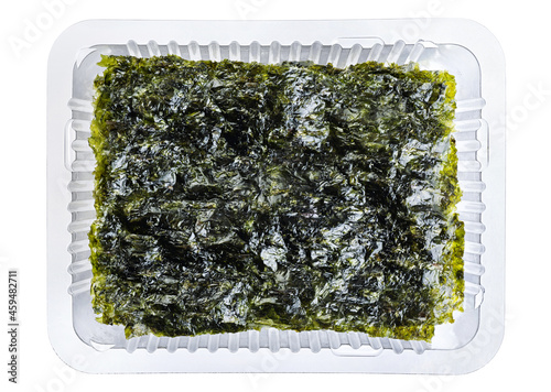 Crispy nori seaweed korean snack in a plastic container isolated on white background. With clipping path.