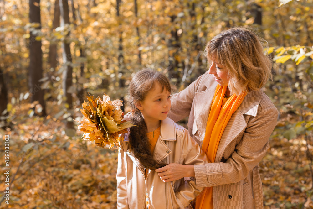 Beautiful lifestyle autumn photo mother and child walks evening in the park, warm sunlight. Beautiful lifestyle autumn photo mother and child walks evening in the park, warm sunlight.