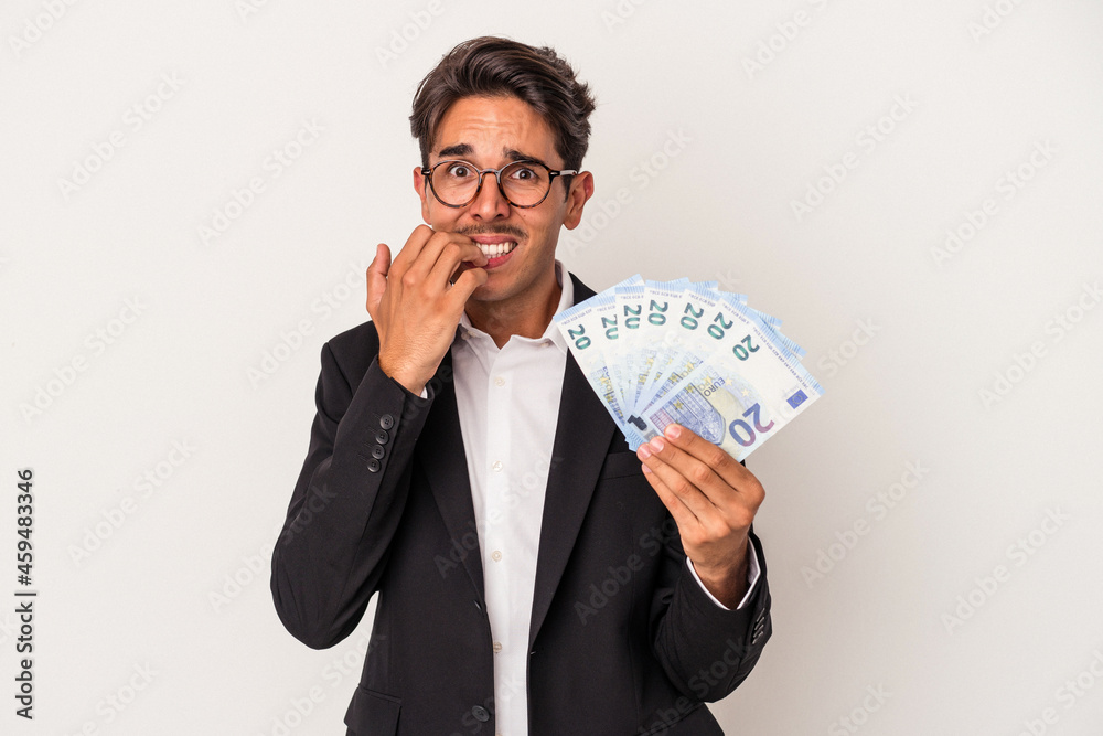 Young mixed race business man holding bills isolated on white background biting fingernails, nervous and very anxious. Young mixed race business man holding bills isolated on white background biting fingernails, nervous and very anxious.