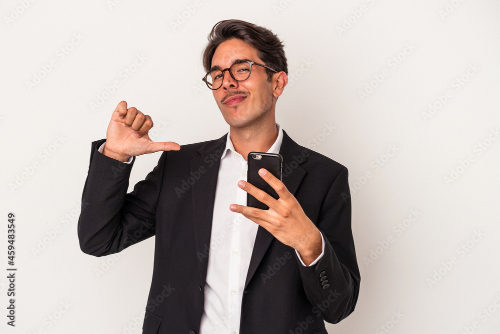 Young mixed race business man holding mobile phone isolated on white background feels proud and self confident, example to follow. Young mixed race business man holding mobile phone isolated on white background feels proud and self confident, example to follow.