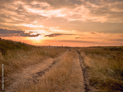 country road in the field and sunset