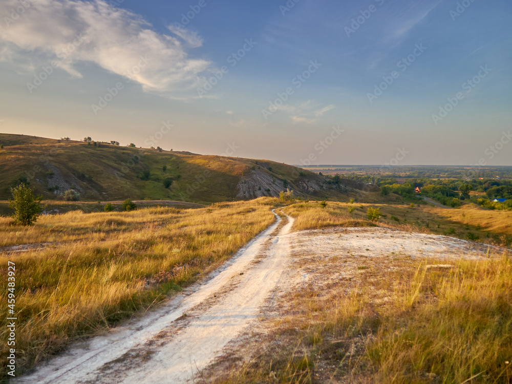 a country road among the chalk hills at dawn