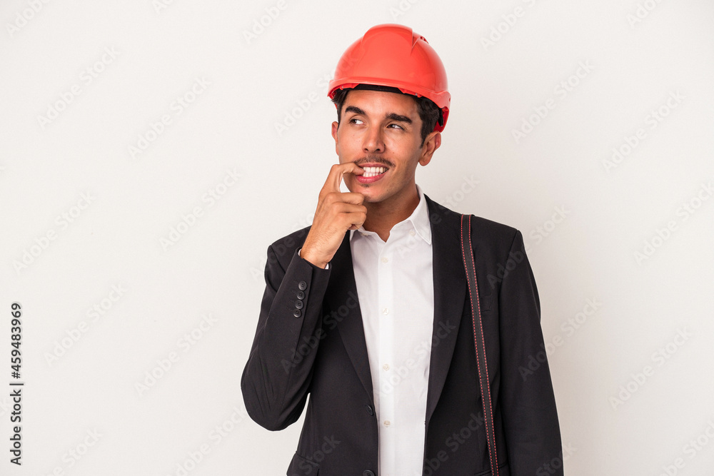 Young architect mixed race man isolated on white background relaxed thinking about something looking at a copy space. Young architect mixed race man isolated on white background relaxed thinking about something looking at a copy space.