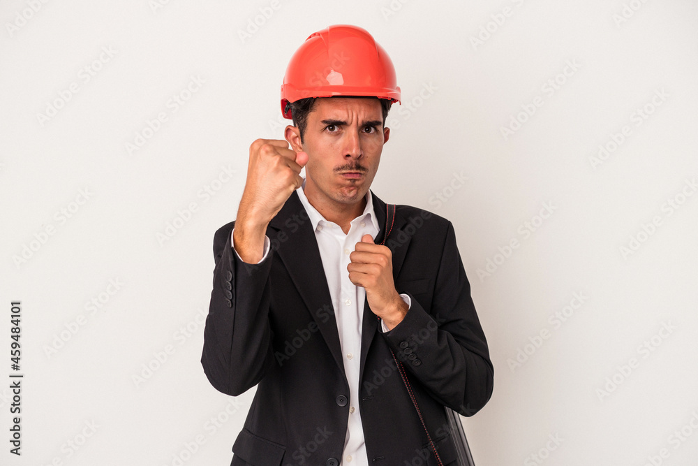 Young architect mixed race man isolated on white background showing fist to camera, aggressive facial expression.