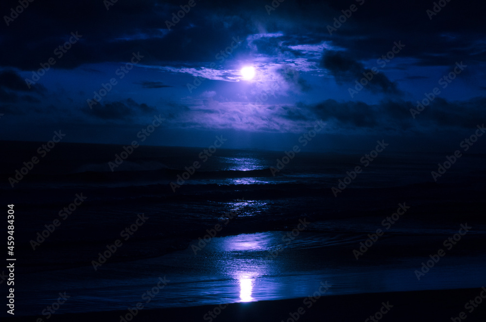 Mar durante a noite com a luz do luar refletindo nas águas
